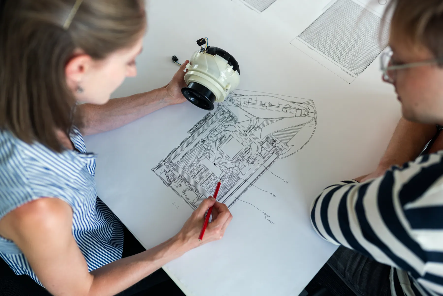 Engineers reviewing a technical drawing together